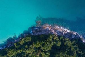 Amazing top view seashore Aerial view of Tropical beach sea in the beautiful Phuket island. Beautiful ocean beach at Phuket Thailand photo