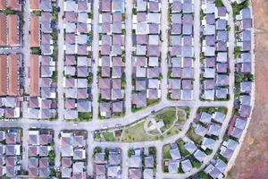 New development real estate. Aerial view of residential houses and driveways neighborhood during a fall sunset or sunrise time.Tightly packed homes.Top down view over private houses in phuket thailand photo