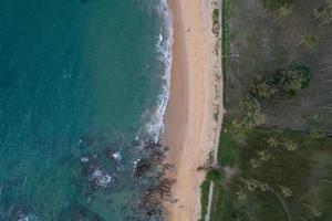 Aerial view of sandy beach and ocean with waves crashing on beach Amazing nature landscape. photo