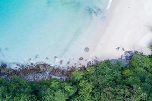 Aerial view Top down seashore wave crashing on seashore Beautiful turquoise sea surface in sunny day Good weather day summer background Amazing beach top view photo