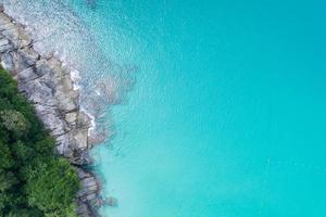 Aerial view Top down seashore wave crashing on seashore Beautiful turquoise sea surface in sunny day Good weather day summer background photo