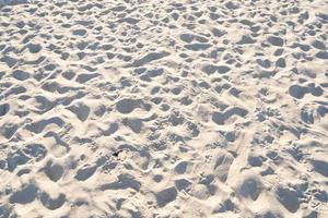 Detail of texture sand in tropical island Summer background and travel design High Quality Detail Of Curve sand texture.Footprints on sand beach photo