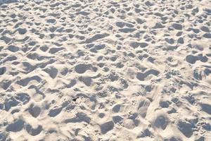 Detail of texture sand in tropical island Summer background and travel design High Quality Detail Of Curve sand texture.Footprints on sand beach photo