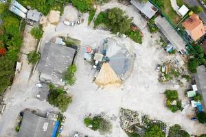 Aerial view panorama top down of Visible cement storage towers and concrete mixing machines.heap of sand and gravel. Industrial background concept photo