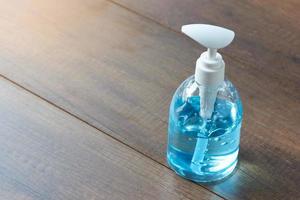 A bottle of hand sanitizer on wooden background photo