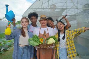 A young diverse group having fun and enjoy emotion in plantation organic's farm greenhouse. photo