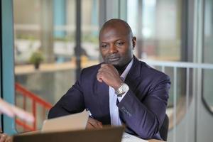 African American Entrepreneur and collaborating with coworkers over network internet 5G technology. photo