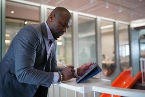 African American Entrepreneur and collaborating with coworkers over network internet 5G technology. photo