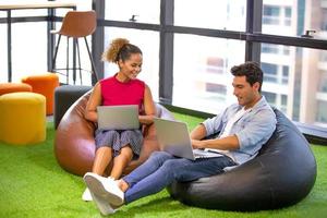 Multiracial business people working on new project marketing plan, meeting inside the modern office. photo