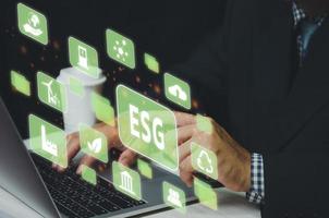 Businessman touching ESG Environmental Social Governance virtual screen Internet Business Technology Concept. photo