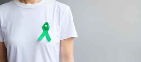 green Ribbon for Liver, Gallbladders, bile duct, cervical, kidney Cancer and Lymphoma Awareness month. Healthcare and world cancer day concept photo