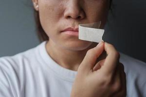 woman with mouth sealed in adhesive tape. Free of speech, freedom of press, Human rights, Protest dictatorship, democracy, liberty, equality and fraternity concepts photo