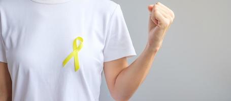 Yellow Ribbon for supporting people living and illness. September Suicide prevention day, Childhood, Sarcoma and bone cancer awareness month concept photo