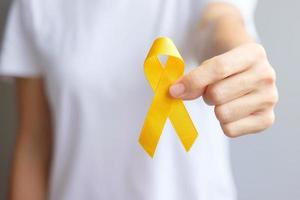 Suicide prevention day, Sarcoma, bone, bladder and Childhood cancer Awareness month, Yellow Ribbon for supporting people living and illness. children Healthcare and World cancer day concept photo