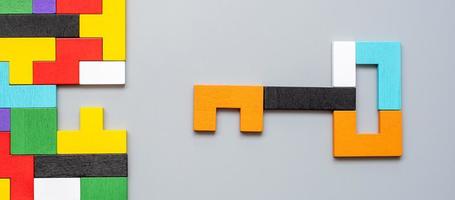 Key and keyhole shape of geometric colorful wood puzzle pieces. logical thinking, business logic, Conundrum, decision, solutions, rational, mission, success, goals and strategy concepts photo