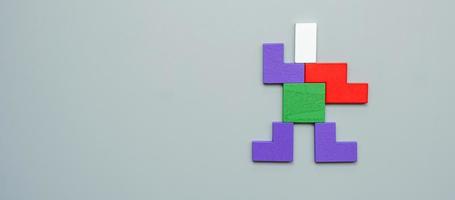 Man shape block of colorful wood puzzle piece on gray background. logical thinking, business logic, Conundrum, decision, solutions, rational, and idea concepts photo