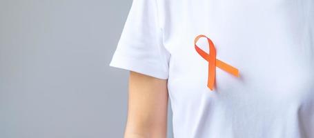 Orange Ribbon for Leukemia, Kidney cancer day, world Multiple Sclerosis, CRPS, Self Injury Awareness month. Healthcare and word cancer day concept photo