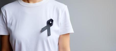 black Ribbon for Melanoma and skin cancer, Vaccine injury awareness month, grief and rest in peace. Healthcare and Racist concept photo