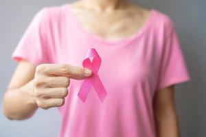 October Breast Cancer Awareness month, elderly Woman in pink T- shirt with hand holding Pink Ribbon for supporting people living and illness. International Women, Mother and World cancer day concept photo