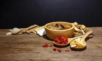 bowl of chinese soup against black photo