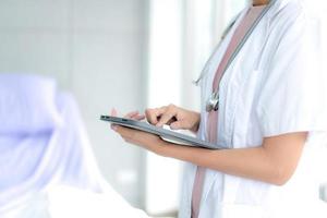 Telemedicine concept.  Hands doctor using tablet computer. Doctor online virtual consultation, chatting to patient, video call, virtual appointment on app. photo