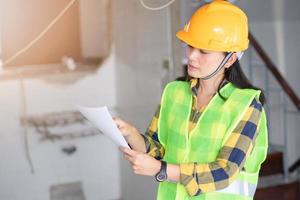 Engineers hold paperwork at structure building for work on site photo