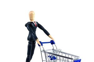 Classic Shopping cart trolley with wooden doll on white background photo