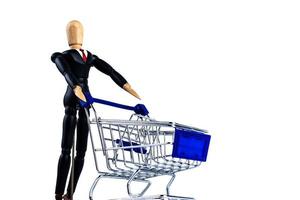 Classic Shopping cart trolley with wooden doll on white background photo