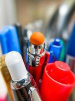 Wide angle macro shot of colorful pens in the cup , selective focus photo