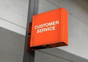 Orange customer service sign board on a metal pole photo