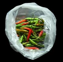 fresh red green chillies in plastic bags photo