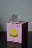 wooden tissue box  painted in the shape of a hamburger. photo