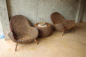 Two rattan chairs and a rattan table photo