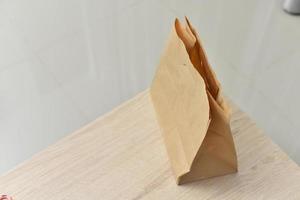 Paper bags placed on a wooden table photo