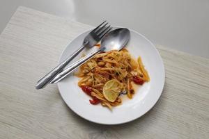 Papaya salad in a white plate and cutlery photo