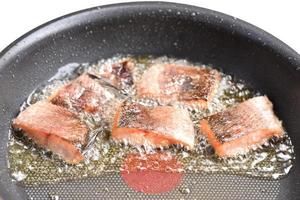 Sun-dried snakehead fish fried in a pan with vegetable oil photo