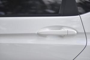 close up of white car door handle photo