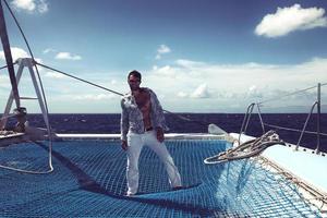 Young man sailing his boat on the open ocean photo