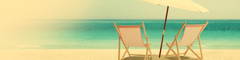 Relax on tropical beach in the sun on deck chairs. photo