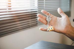 Real estate agent handing over a house key photo
