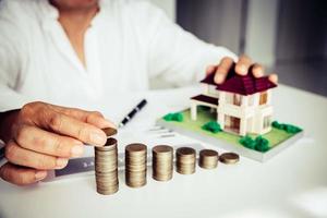 Business man putting coin increase on coins stacking photo