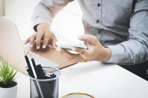 Business men are using their mobile phones to connect with their partners to talk about adjusting their profitable strategies. photo