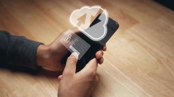 Man using smartphone with virtual cloud computing and Login virtual interfaces.Cloud computing system and internet network security technology. photo