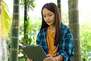 female farmer is happy after viewing results from a laptop computer. Increased profits photo