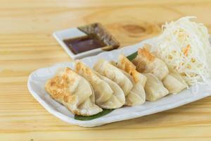 Japanese gyoza or dumplings snack with soy sauce photo