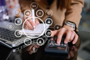 Businessman using mobile phone and laptop computer on white desk big data analytics with business intelligence concept. with VR icon photo