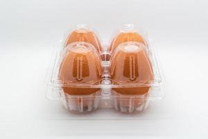 Fresh four Eggs in closed transparent plastic packaging photo