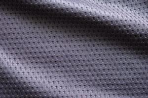 Gray fabric sport clothing football jersey with air mesh texture background photo