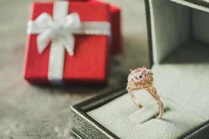 jewelry pink diamond ring with red gift box background photo