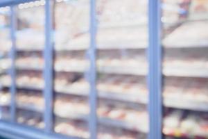 refrigerator shelves with meat in supermarket blur background photo